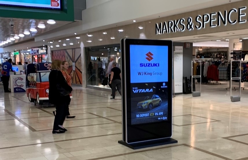 Digital advertising screen in a busy shopping centre