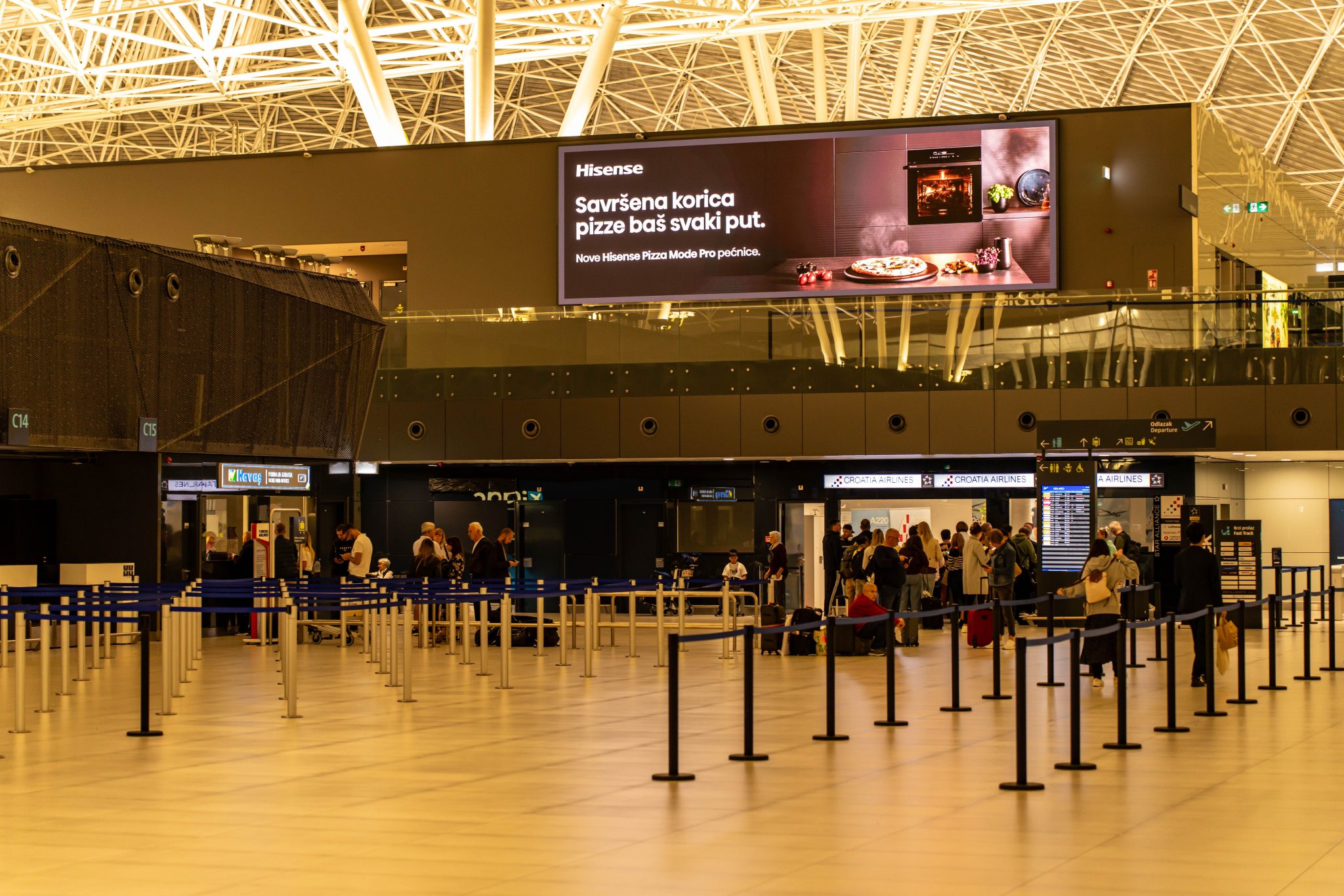 Large digital advertising screen inside an airport terminal