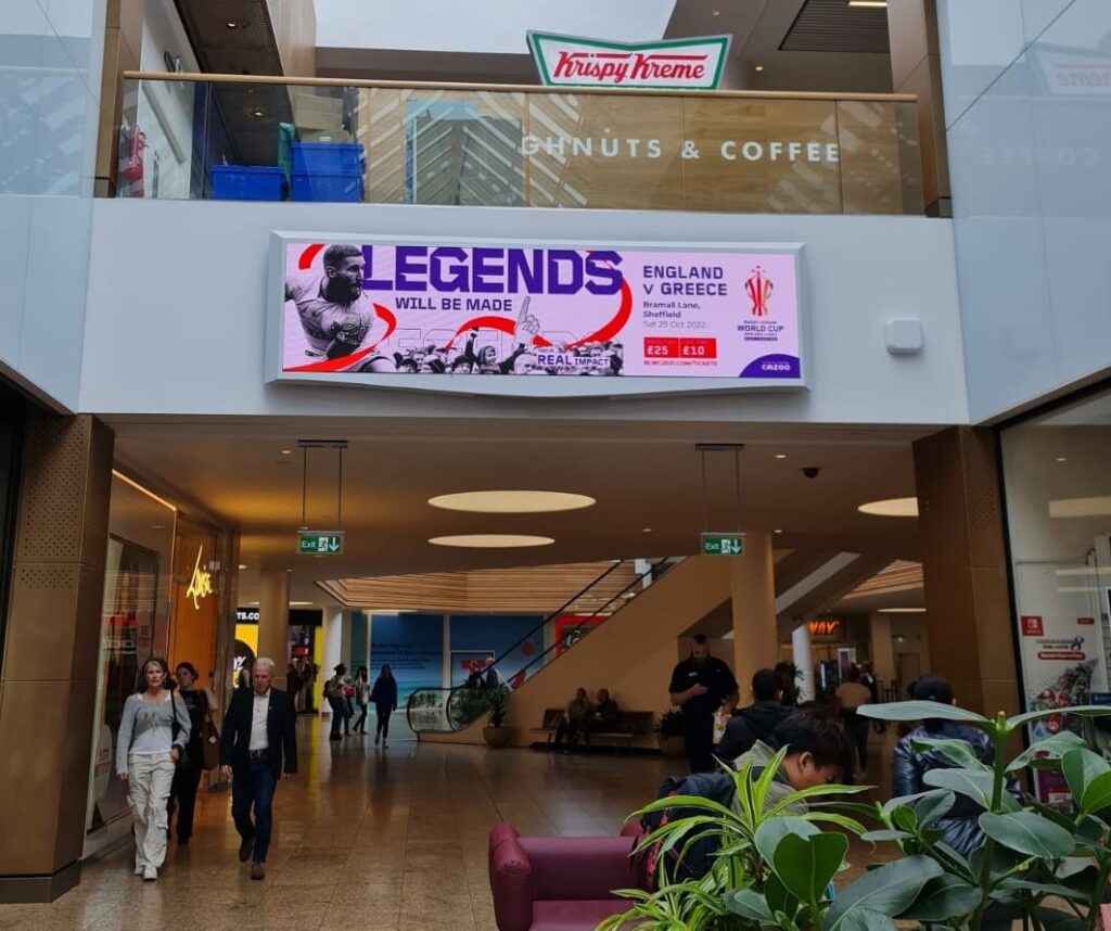 Digital advertising screen inside a busy shopping centre