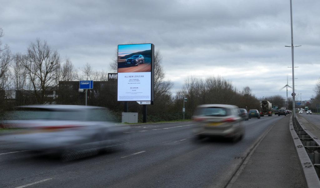 Digital roadside billboard beside a busy UK road